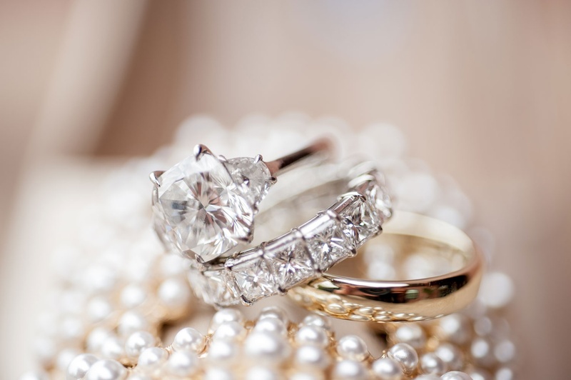 Gold Men's Band %26 Diamond Women's Rings
Photography: Triple Cord Photography
Read More:
http://www.insideweddings.com/weddings/destination-wedding-with-outdoor-reception-lavish-after-party/982/ Bride wedding ring engagement ring with side stones and eternity band polished gold ring for groom