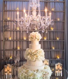 Cake Displayed Under Chandelier
Photography: KLK Photography
Read More:
http://www.insideweddings.com/weddings/nature-inspired-alfresco-ceremony-tent-reception-at-malibu-ranch/811/ extravagant wedding cake with garden roses and peonies displayed on mirrored table under chandelier
