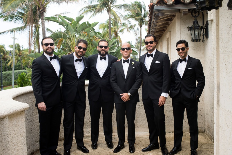 Groomsmen in Tuxes %26 Sunglasses
Photography: Nancy Cohn Photography
Read More:
http://www.insideweddings.com/weddings/destination-wedding-with-white-gold-color-palette-in-palm-beach/1028/ Groom in sunglasses and bow tie tuxedo with groomsmen in matching outfits on balcony