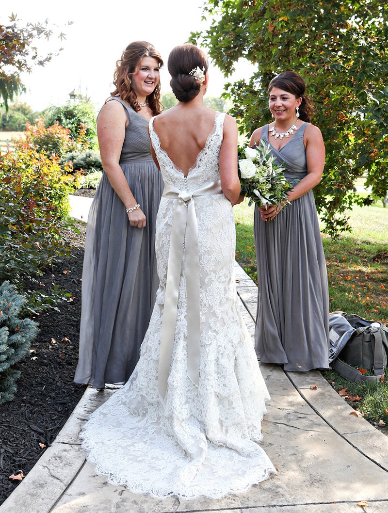 Bride's Sleeveless Lace Gown
Photography: Stacy Newgent
Read More:
http://www.insideweddings.com/weddings/rustic-barn-wedding-tented-reception-on-family-farm-in-ohio/690/ Bride in Alvina Valenta lace gown with V-back, satin sash, chapel train, bridesmaids in J.Crew