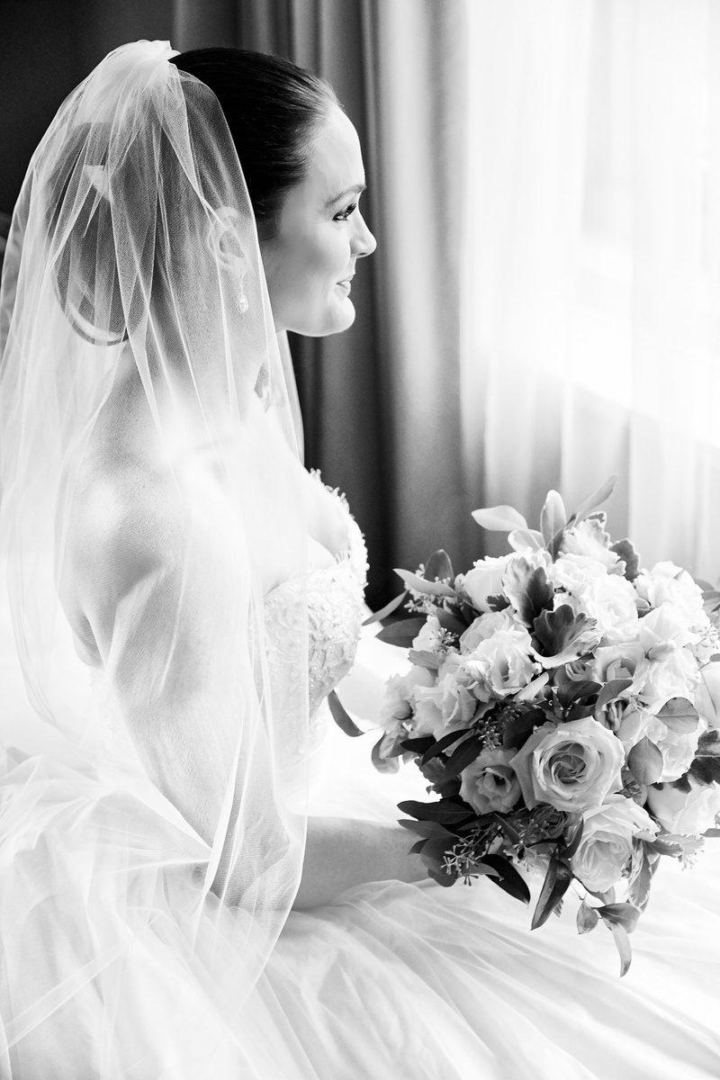 Bride in Veil Looking Out Window
Photography: KingenSmith
Read More:
http://www.insideweddings.com/weddings/opulent-wedding-with-organic-textures-elegant-decor-in-chicago/1010/ Black and white photo of bride in wedding dress with veil over updo looking out window with bouquet