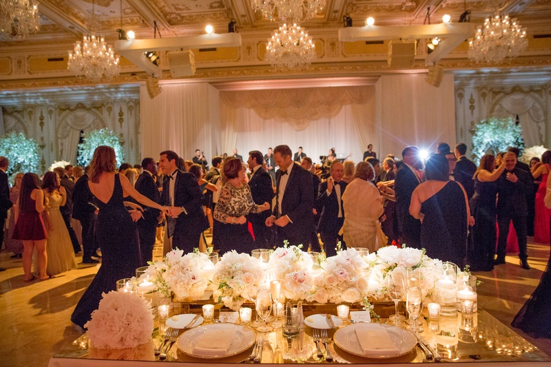 View of Guests from Sweetheart Table
Photography: Nancy Cohn Photography
Read More:
http://www.insideweddings.com/weddings/destination-wedding-with-white-gold-color-palette-in-palm-beach/1028/ Wedding reception guests on dance floor view from bride and groom seats in ballroom chandeliers