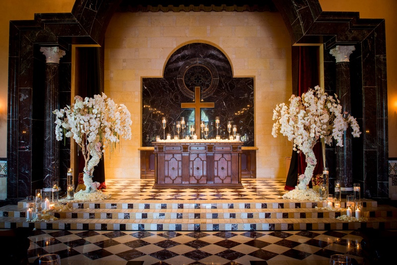 Orchid-Wrapped Trees Frame Altar
Photography: Boyd Harris Photographs
Read More:
http://www.insideweddings.com/weddings/a-jeweled-floral-wedding-at-fairmont-grand-del-mar-in-san-diego/745/ wedding altar at Grand Del Mar chapel framed by tree arrangements wrapped in orchid flowers