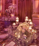 Elegant Wedding Centerpiece
Photography: Gruber Photographers
Read More:
http://www.insideweddings.com/weddings/opulent-new-york-city-wedding-with-violet-lighting/395/ Tall glass candleholders with white rose centerpiece