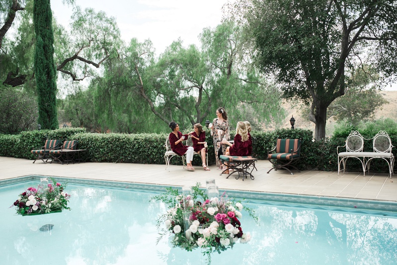 Bride and Bridesmaids by the Pool
Photography: Dmitry Shumanev Production
Read More:
http://www.insideweddings.com/weddings/romantic-wedding-with-lush-florals-in-autumnal-hues/1172/ bride in flowy floral robe, bridesmaids in burgundy velvet robes, pool with floating florals