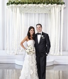 Bride and Groom Pose Under Chuppah
Photography: KingenSmith
Read More:
http://www.insideweddings.com/weddings/modern-jewish-wedding-with-unique-details-and-deep-color-palette/929/ bride in oscar de la renta, groom in j. hilburn under chuppah of flowers and ribbons