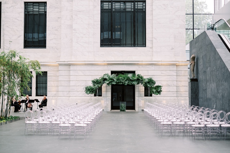 Modern Museum Wedding Ceremony
Photography: Lauren Gabrielle Photography
Read More:
http://www.insideweddings.com/weddings/summer-real-wedding-featuring-tropical-decor-at-an-art-museum/1328/ wedding ceremony cleveland museum of art oval clear guest chairs and tropical greenery chuppah