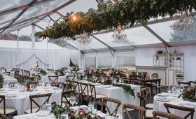 Tent Reception with Wood %26 Greenery
Photography: Cadence %26 Eli Photography
Read More:
http://www.insideweddings.com/weddings/romantic-woodsy-autumn-at-home-tented-wedding-in-minnesota/1271/ wedding reception tent clear top wood vineyard chairs greenery chandelier low centerpieces