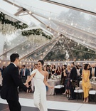 Bride in Jumpsuit for First Dance
Photography: Sam %26 Sola Lee Photography
Read More:
http://www.insideweddings.com/weddings/modern-outdoor-ceremony-tent-reception-in-seattle-on-puget-sound/1309/ bride changed into one shoulder white jumpsuit for dance clear tent string lights black white floor