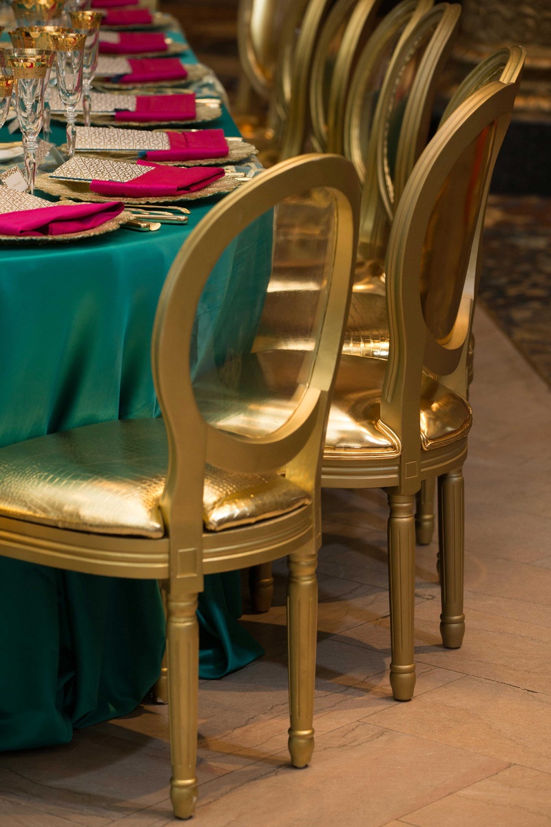 Gold, Shimmering Chairs, Bold Linens
Photography: Collin Pierson Photography
Read More:
http://www.insideweddings.com/weddings/bold-and-bright-wedding-styled-shoot-inspired-by-marrakesh-morocco/825/ gold shiny cushioned chairs at bold blue linens with bright pink napkins
