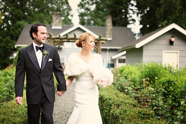 Groom And Bride Wearing White Fur Shrug Over Dress Groom And Bride Wearing White Fur Shrug Over Dress