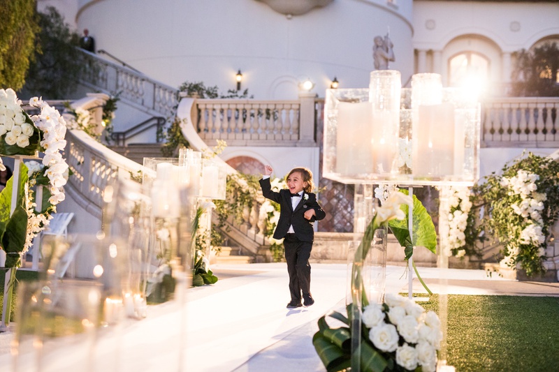Ring Bearer on Candlelit Aisle
Photography: Samuel Lippke Studios
Read More:
http://www.insideweddings.com/weddings/outdoor-jewish-wedding-ceremony-luxe-reception-in-california/1160/ Wedding ceremony evening jewish custom ring bearer in tuxedo walking down white aisle candles lights