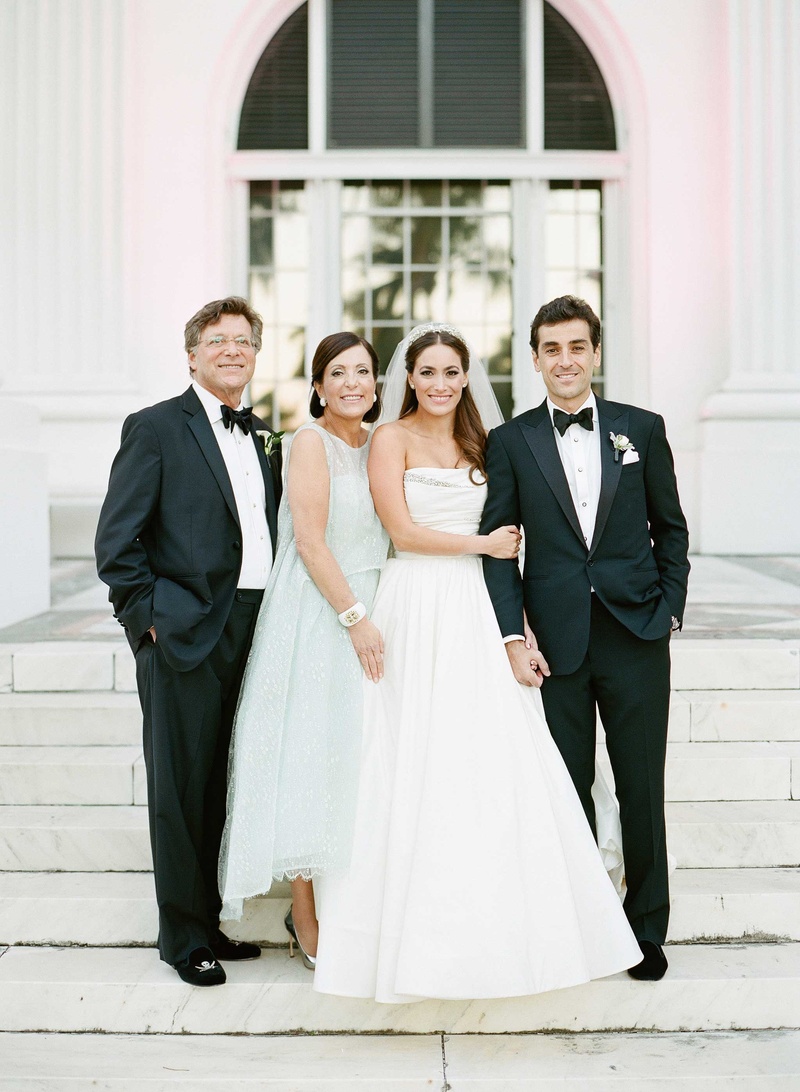 Couple with Bride's Mother and Father
Photography: Kat Braman Photography
Read More:
http://www.insideweddings.com/weddings/a-sophisticated-museum-wedding-with-modern-details-in-palm-beach/899/ Light blue green pastel mother of bride Monique Lhuillier dress with father of bride in tuxedo