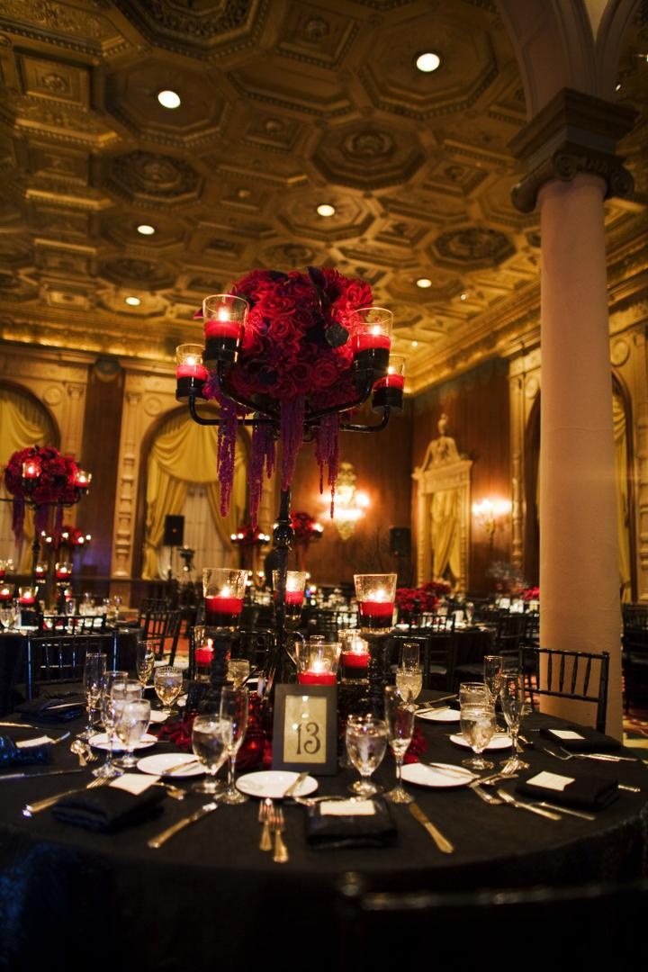 Table Décor
Photography: Barnet Photography
Read More:
http://www.insideweddings.com/weddings/ashley-reeves-and-brandon-saller/261/ Wedding reception table with black candelabra with red candles floating in red water and red roses