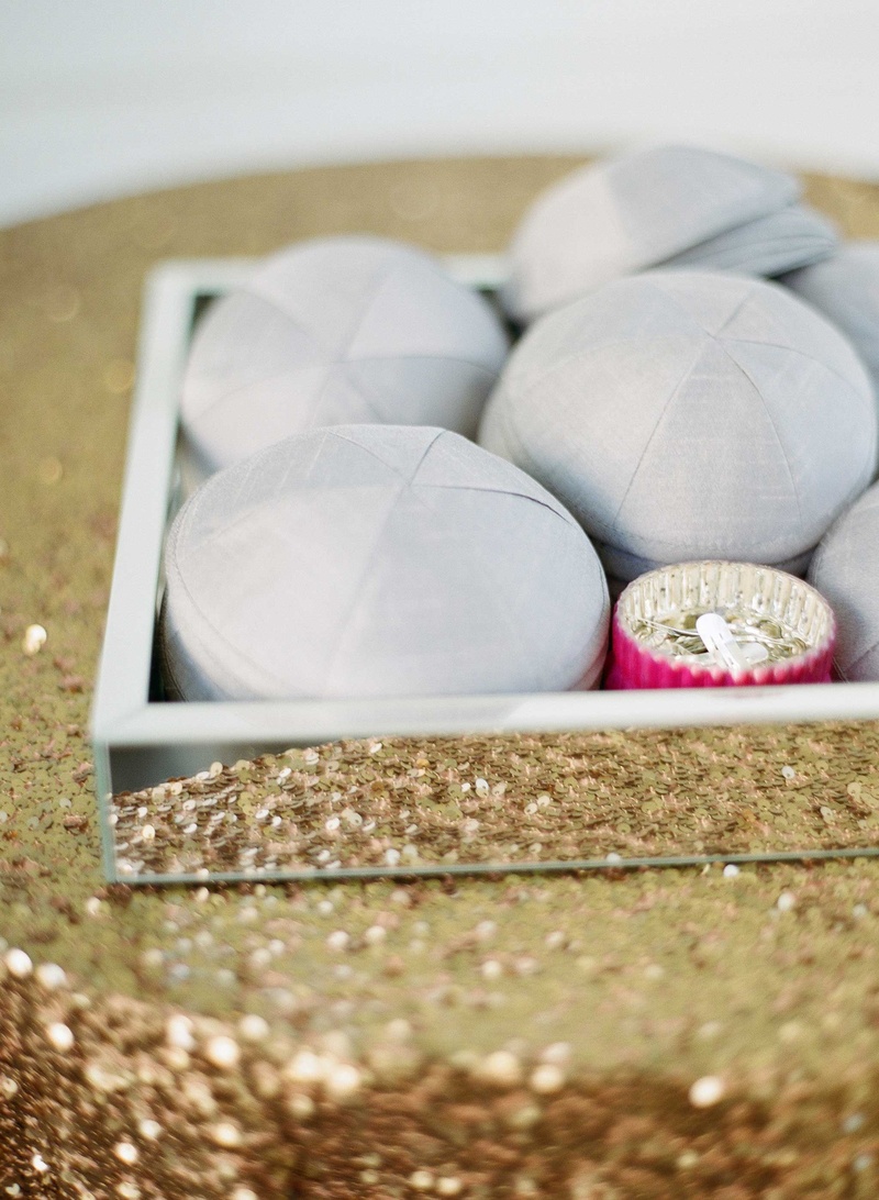 Yarmulkes in Mirror Tray on Gold Table
Photography: Kat Braman Photography
Read More:
http://www.insideweddings.com/weddings/a-sophisticated-museum-wedding-with-modern-details-in-palm-beach/899/ Gold sequin table linen with mirror tray grey yarmulke for Jewish wedding in Palm Beach Florida