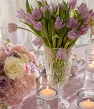 Purple Tulips in Crystal Vase
Photography: Collin Pierson Photography
Read More:
http://www.insideweddings.com/weddings/styled-spring-wedding-shoot-with-lavender-blush-silver-decor/1114/ Wedding reception low centerpiece purple tulip flowers next to floating candles low centerpiece