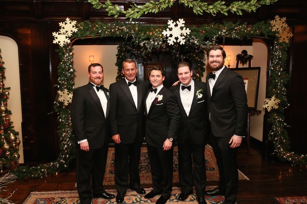 Groom With Dad And Groomsmen In Front Of Christmas Decorations Groom With Dad And Groomsmen In Front Of Christmas Decorations
