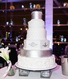 Six-Layer White %26 Silver Cake
Photography: Sterling Imageworks
Read More:
http://www.insideweddings.com/weddings/sophisticated-soiree-at-a-presidential-library-in-little-rock/1033/ Wedding cake on legs with white silver and cream decorations different designs on each layer