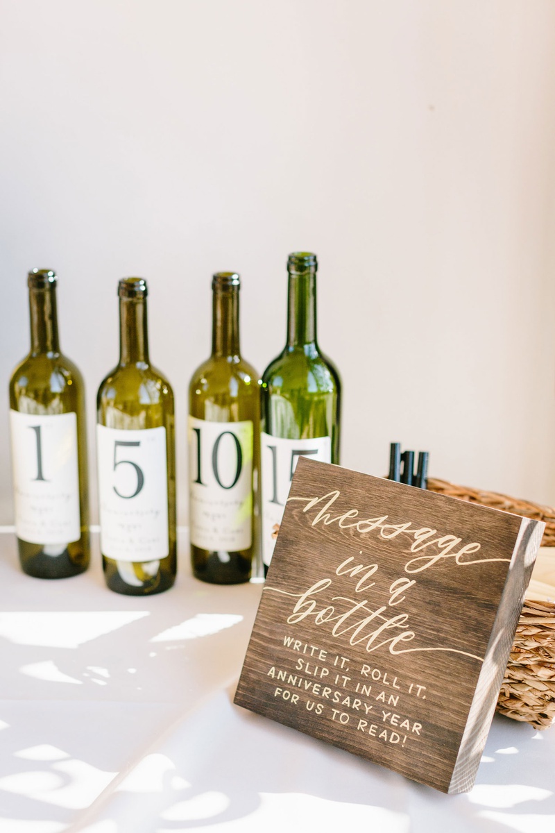 Message in a Bottle "Guest Book"
Photography: Jodee Debes Photography
Read More:
http://www.insideweddings.com/weddings/outdoor-ceremony-reception-with-bright-color-palette-at-la-ranch/1280/ wedding ceremony reception guest book alternative message in a bottle write it roll it wood sign