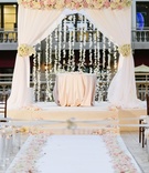 Chuppah with Cascading Orchids.
Photography: Brian Leahy Photography
Read More:
http://www.insideweddings.com/weddings/a-classic-romantic-celebration-with-lush-florals-in-beverly-hills/973/ chuppah with white drapery, blush and ivory roses, and hanging orchids
