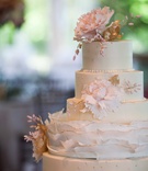 White Wedding Cake with Pink Floral Details
Photography: Michael Bambino %26 Co.
Read More:
http://www.insideweddings.com/weddings/whimsical-open-air-secret-garden-wedding-with-soft-spring-hues/777/ delicate five tier white wedding cake with pink flowers and gold detailing ruffles