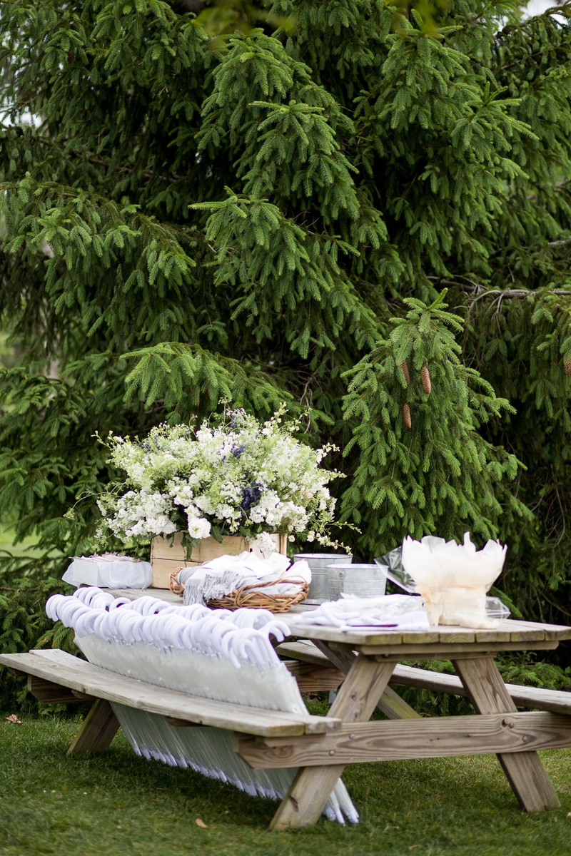 Parasols %26 Pashminas at Picnic Table
Photography: Roey Yohai Studios
Read More:
http://www.insideweddings.com/weddings/romantic-new-york-real-wedding-with-upscale-summer-camp-feel/1327/ outdoor wedding ceremony wood picnic table with pashmina throws in baskets umbrella parasols more