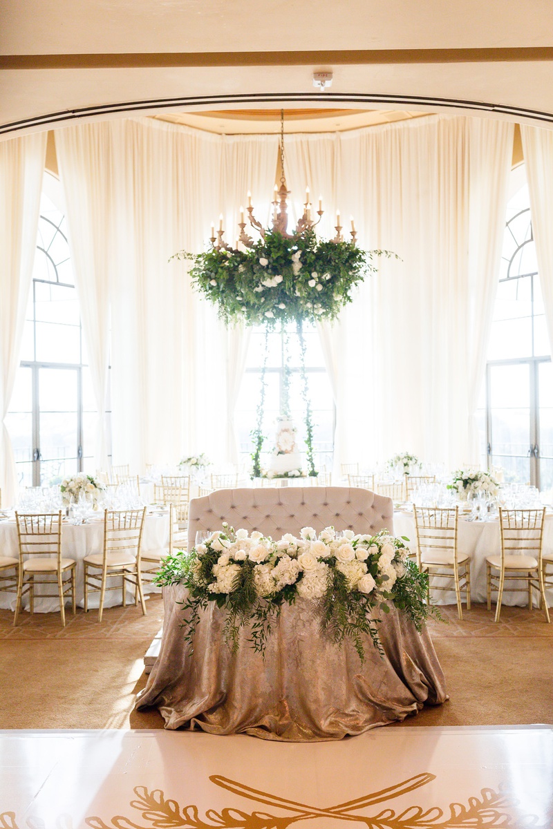Luxe Sweetheart Table
Photography: Chard Photo
Read More:
http://www.insideweddings.com/weddings/alfresco-ceremony-on-the-coast-classic-ballroom-reception/1290/ tufted love seat for sweetheart table with metallic linens and arrangement of white flowers, foliage