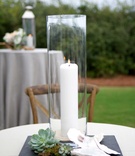 Tall Glass Case for White Candle
Photography: Arden Photography
Read More:
http://www.insideweddings.com/weddings/chic-coastal-wedding-with-oyster-inspired-details-in-florida/850/ tall glass case candle white succulents greenery shells wooden chair reception décor