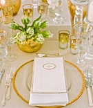 Gold-Rimmed Charger
Photography: Aaron Delesie Photographer
Read More:
http://www.insideweddings.com/weddings/elegant-all-white-country-club-wedding-with-natural-greenery/530/ Gold candle votives, vases, glasses, and charger at wedding