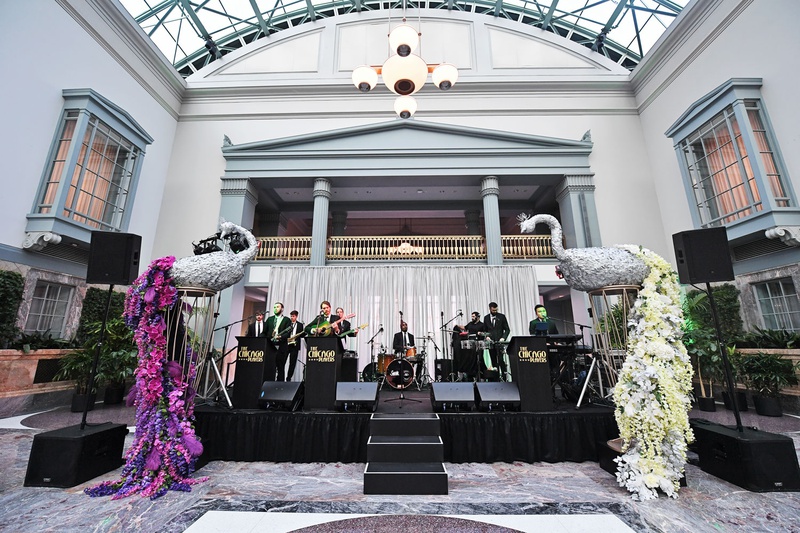 Peacock Décor with Floral Trains
Photography: Carasco Photography
Read More:
http://www.insideweddings.com/weddings/personalized-fairy-tale-wedding-with-fun-entertainment-in-chicago/1283/ wedding band at chicago harold washington library silver peacock sculpture white pink purple flowers