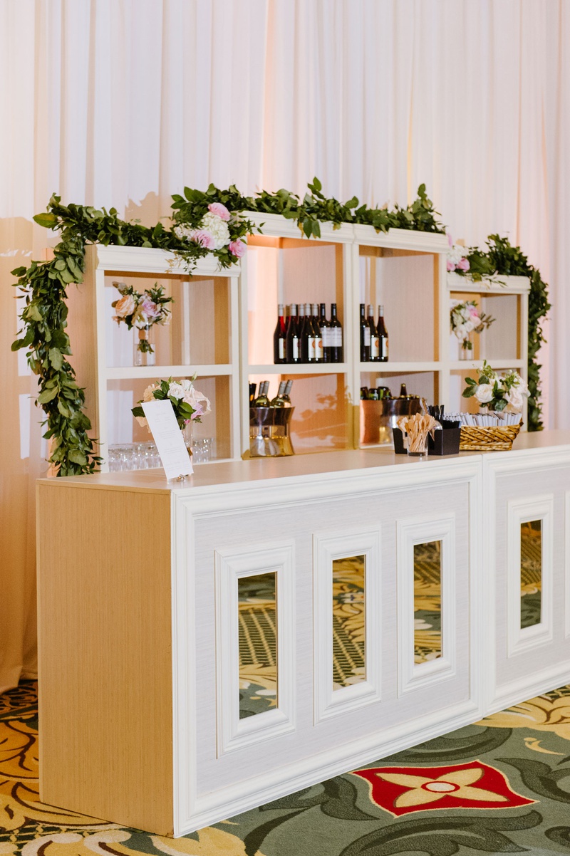 Mirror Bar with Greenery Garland
Photography: Caroline Lima Photography
Read More:
http://www.insideweddings.com/weddings/catholic-ceremony-classic-ballroom-reception-in-charlotte-nc/1314/ wedding reception ballroom white mirror bar with shelves garland pink blush flowers wine