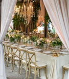 Blush Drapery at Barn Reception
Photography: Samuel Lippke Studios
Read More:
http://www.insideweddings.com/weddings/a-rustic-camp-themed-outdoor-wedding/908/ Long reception table wedding wood chairs low centerpieces greenery chandelier drapes
