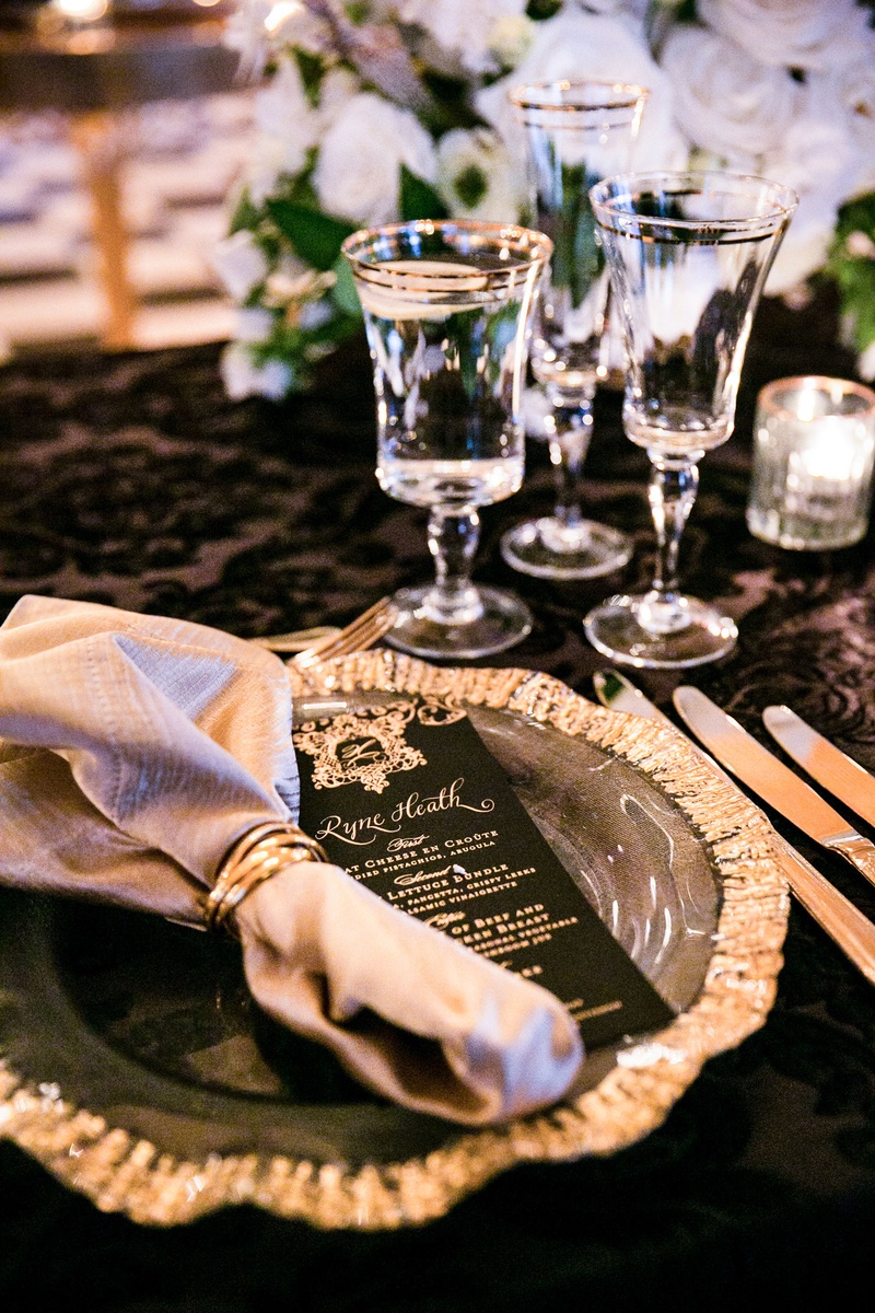 Gold Charger %26 Black Menu Card
Photography: Parker J Pfister Photographer
Read More:
http://www.insideweddings.com/weddings/gorgeous-alfresco-ceremony-tented-reception-at-a-luxurious-estate/1044/ Wedding reception black linens table gold rim glassware and charger black gold menu card calligraphy