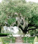 Wedding Ceremony Under Large Tree
Photography: Jennings King Photography
Read More:
http://www.insideweddings.com/weddings/alfresco-spring-destination-wedding-in-charleston-south-carolina/1277/ wedding ceremony in south carolina white flower greenery on both sides of vow exchange spot shrubs
