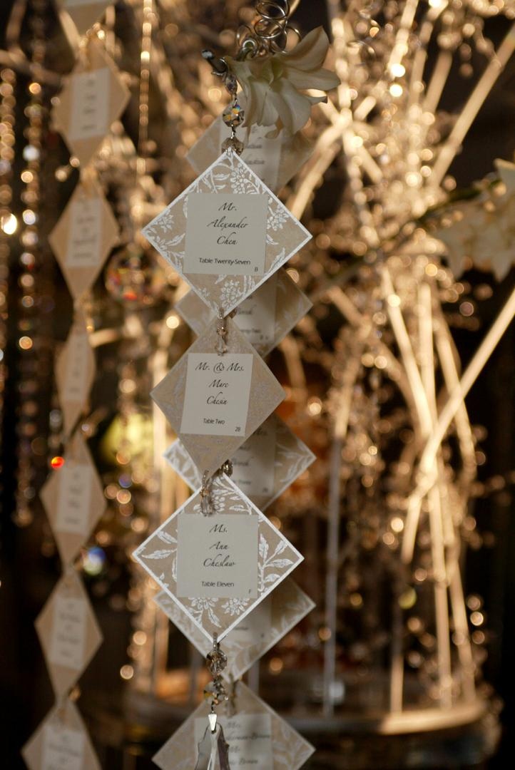 Unique Escort Card Display
Photography: Lyn Sims Photographer
Read More:
http://www.insideweddings.com/weddings/glamorous-fall-wedding-with-garden-touches-in-tucson-arizona/258/ Suspended crystal and metallic seating cards