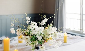 Centerpiece with Extending Branches
Photography: O’Malley Photographers
Read More:
http://www.insideweddings.com/weddings/a-sweet-springtime-tablescape-with-a-soft-neutral-color-palette/1059/ small flower arrangement with white japaense ranunculuses and corylopsis extending