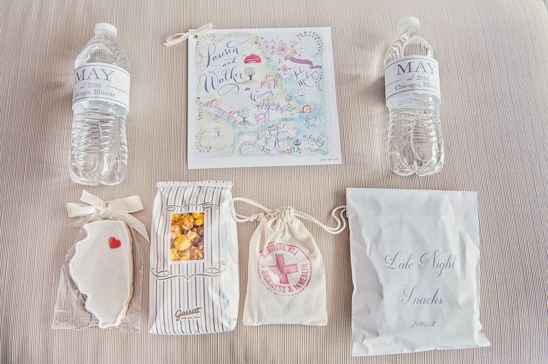 Welcome Bag Gifts for Chicago Wedding
Photography: Carasco Photography
Read More:
http://www.insideweddings.com/weddings/traditional-ceremony-glamorous-garden-inspired-tented-reception/943/ Welcome bag for Chicago wedding cookie water botle map popcorn emergency kit and snacks
