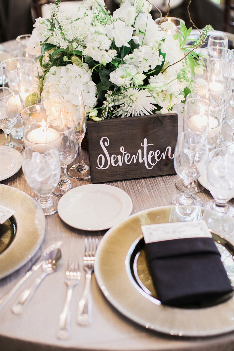 Wooden Table Number with White Calligraphy
Photography: This Modern Romance
Read More:
http://www.insideweddings.com/weddings/rustic-chic-wedding-with-wooden-accents-and-verdant-details/861/ dark rectangular piece of wood with white calligraphy for wedding table number