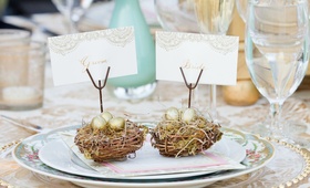 Rustic Nest Place Card Holders
Photography: Thisbe Grace Photography
Read More:
http://www.insideweddings.com/weddings/outdoor-wedding-with-pink-gold-decor-at-a-vineyard-in-california/691/ Outdoor wedding reception table with small nests & golden eggs holding bride & groom placecards