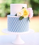 Simple Two-Layer Wedding Cake
Photography: Bonnie Sen Photography
Read More:
http://www.insideweddings.com/weddings/outdoor-ceremony-tented-reception-by-a-tranquil-river-in-maryland/1088/ Wedding cake just for cutting blue and white diamond design on bottom fresh flowers on top fondant