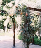 Four-Post Wedding Structure with Greenery
Photography: Mallory Dawn Photography
Read More:
http://www.insideweddings.com/weddings/outdoor-jewish-ceremony-luxe-reception-at-vibiana-in-downtown-la/1259/ wedding ceremony decor outdoor jewish wedding wood arbor with organic greenery leaves asymmetrical