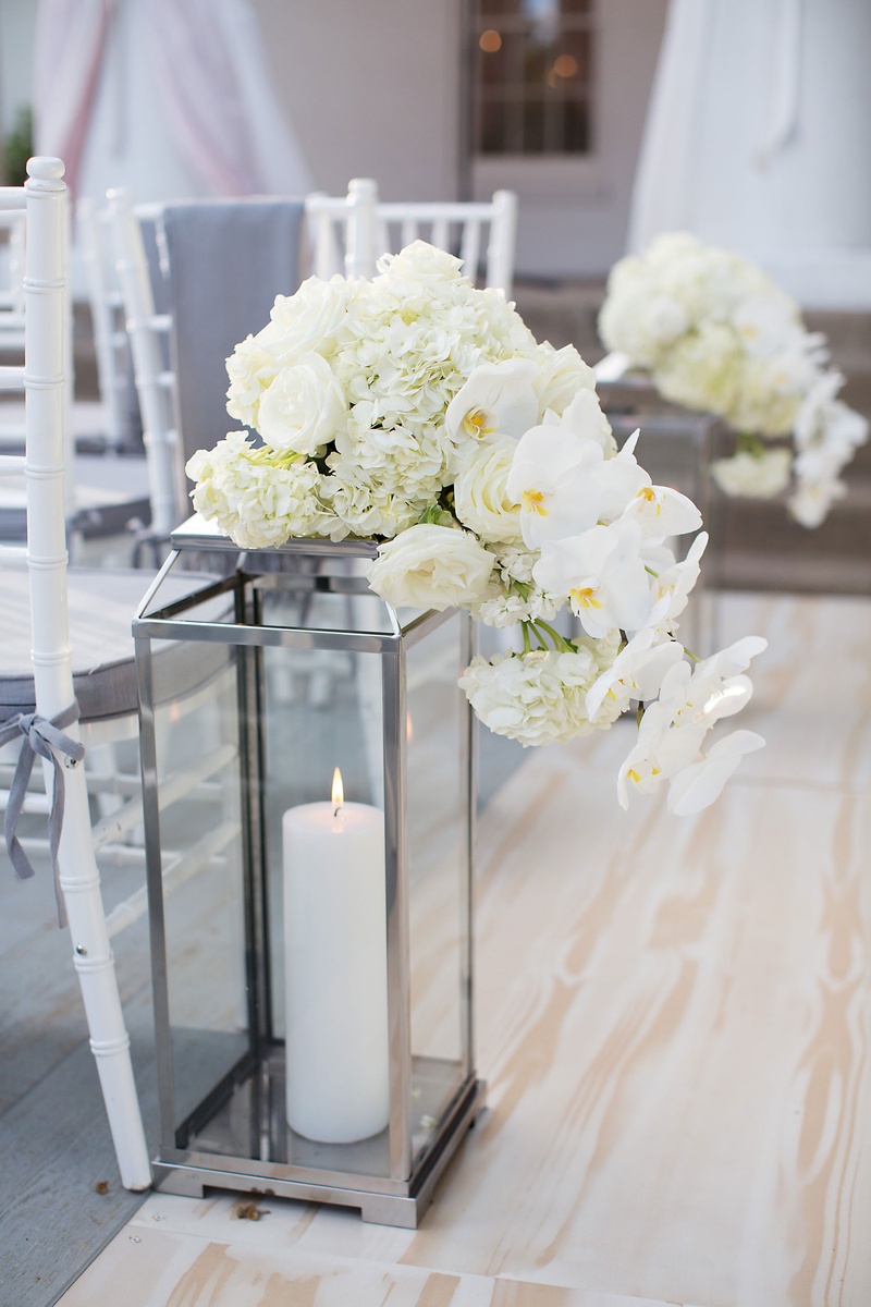 Silver Lantern with Pillar Candle
Photography: Sarah Kate, Photographer
Read More:
http://www.insideweddings.com/weddings/outdoor-fall-ceremony-opulent-tented-reception-in-dallas-texas/1022/ Silver lantern with candle inside decorated with white hydrangea rose and orchid flowers ceremony
