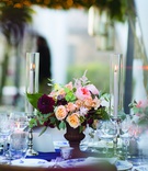 Colorful Florals Between Candles
Photography: The Day by Ira Lippke
Read More:
http://www.insideweddings.com/weddings/romantic-ceremony-on-bluff-tented-reception-in-tuscany/1311/ wedding reception with small floral arrangement with pink, burgundy & peach flowers between candles