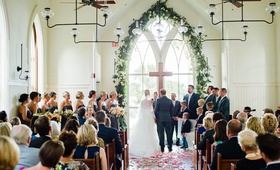 Ceremony at Charming Chapel
Photography: Liz Banfield
Read More:
http://www.insideweddings.com/weddings/destination-fete-with-chapel-ceremony-charming-tented-reception/1179/ wedding ceremony bride and groom altar cross arch window greenery flower petals wood floor pews