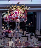Vibrant Floral Arrangements
Photography: Kesha Lambert Photography
Read More:
http://www.insideweddings.com/weddings/romantic-wedding-with-vibrant-purple-decor-and-caribbean-traditions/1138/ wedding reception centerpiece on crystal vase, blue and white hydrangeas, red and pink roses, crysta