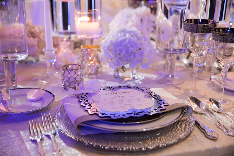 Place Setting %26 Silver Goblets
Photography: Collin Pierson Photography
Read More:
http://www.insideweddings.com/weddings/winter-wedding-inspirational-shoot-with-opulent-frosted-decor/1108/ Wedding reception place setting silver charger plate with menu card candles low centerpiece rimmed