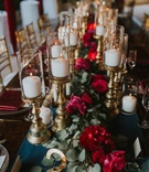 Long Floral Runner with Candles
Photography: Jennifer Martin Photography
Read More:
http://www.insideweddings.com/weddings/a-pro-tennis-players-fall-wedding-featuring-a-moody-color-palette/997/ wedding king's table, red floral garland runner, candles on gold stands