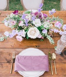 Wood Table with Purple %26 Gold Details
Photography: Petula Pea Photography
Read More:
http://www.insideweddings.com/weddings/romantic-outdoor-hawaiian-destination-wedding-with-lilac-details/1221/ wedding reception rustic wood table purple napkin gold flatware greenery white purple centerpiece
