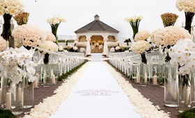 Ivory Oceanfront Wedding
Photography: Bob %26 Dawn Davis Photography
Read More:
http://www.insideweddings.com/weddings/oceanfront-ceremony-opulent-pink-and-metallic-reception/407/ White monogram aisle runner with tons of roses