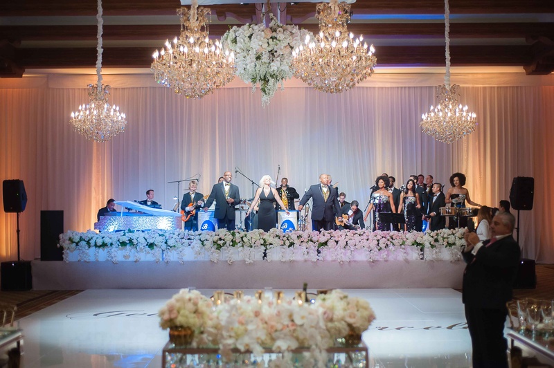 Live Band Performance Under Chandeliers
Photography: The Yodsukars
Read More:
http://www.insideweddings.com/weddings/glam-10th-wedding-anniversary-party-vow-renewal-in-california/917/ Bonnie Foster Productions at wedding reception dance floor chandeliers white flowers around stage